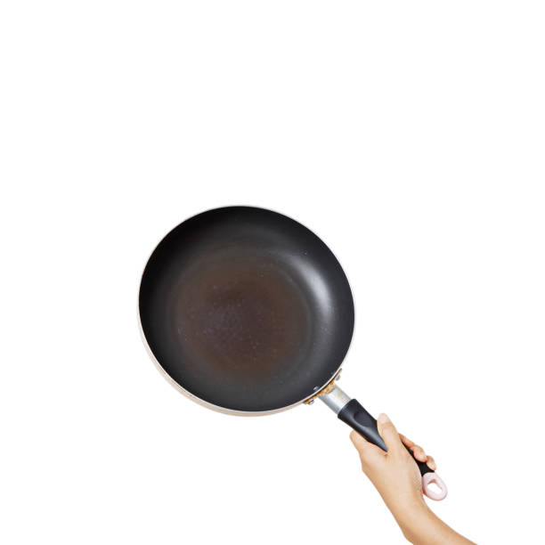 istock Hand holding a frying pan on an isolated white background 1264013275