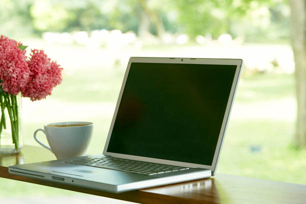 istock Mockup image of laptop with blank screen and coffee cup 1264013282