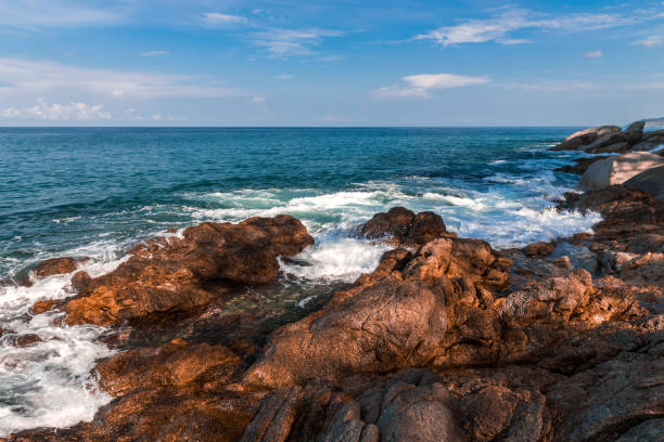 istock Rocky shore of the ocean with breaking waves 1264015791