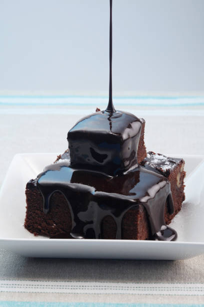 istock Pouring chocolate syrup onto brownies 1264017179
