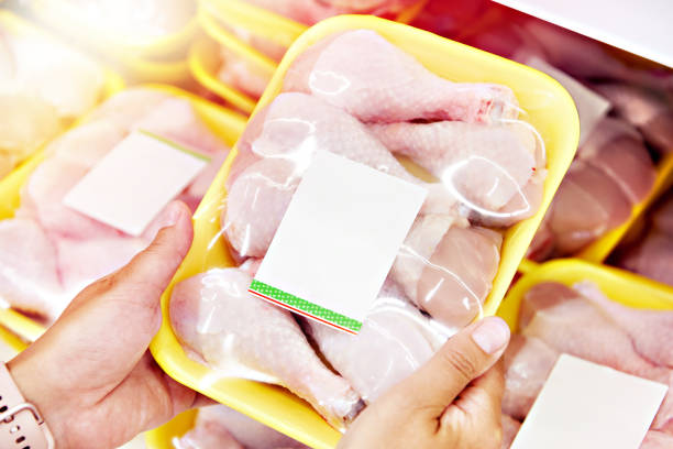 istock Hands with chicken meat in shop 1264022322