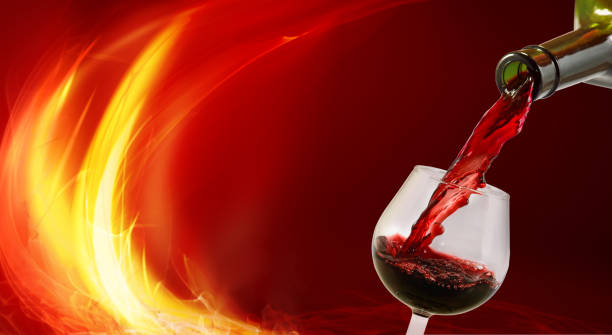 istock Image of a glass into which wine is poured from a bottle. 1264032110