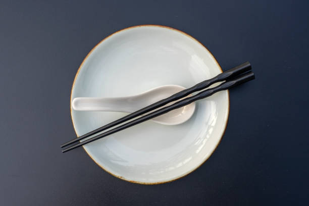 The delicious food on the plate and the chopsticks placed on it