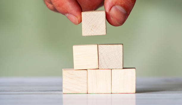 istock Man is placing blank blocks in a row on green background. 1264037065
