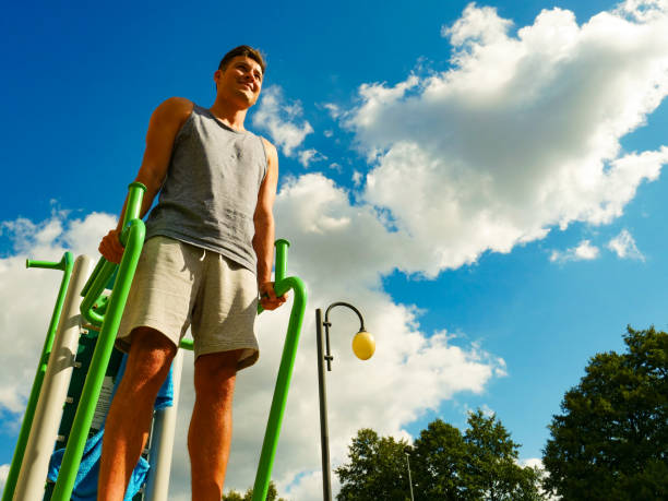 istock Man flexing arms in outdoor gym 1264037303