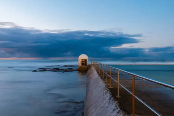 Pumphouse of Merewether rock pool at dawn.