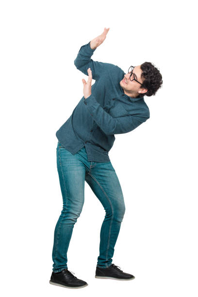 istock Full length portrait scared man keeps hands raised up to protect him from any danger, isolated over white background.  Nerd employee victim of workplace bullying. Helpless guy suffer from family abuse 1264042504