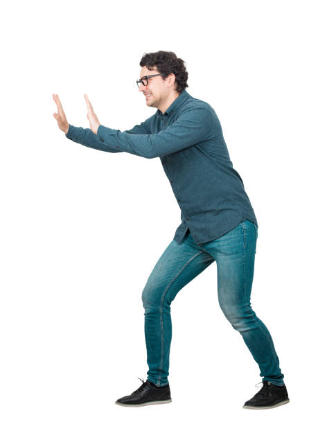 istock Determined businessman makes effort pushing an heavy invisible object isolated on white background. Confident person, difficult task concept, convinced in own powers, finding solutions to problems. 1264044714