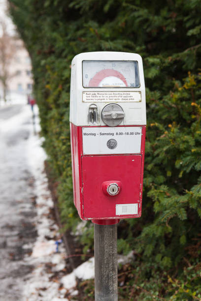 Old German parking meter in winter. Text \