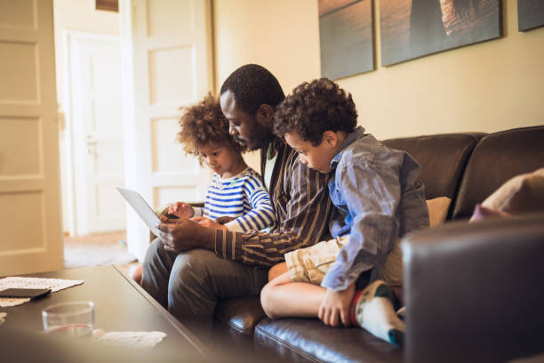 istock Father teaching his kids at home 1264046497