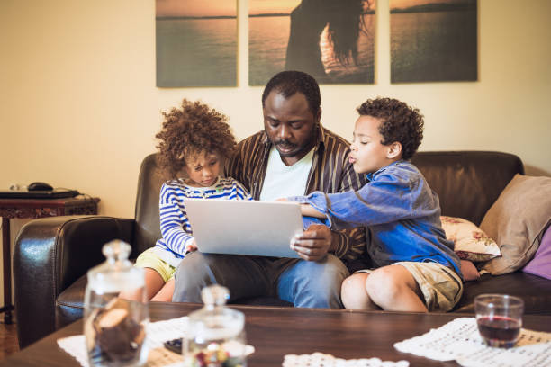 istock Father teaching his kids at home 1264046526