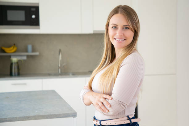 istock Cheerful attractive young woman posing with arms folded 1264048585