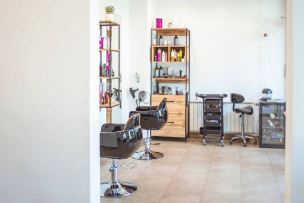 istock Empty black chairs and mirrors in barber shop. 1264049332