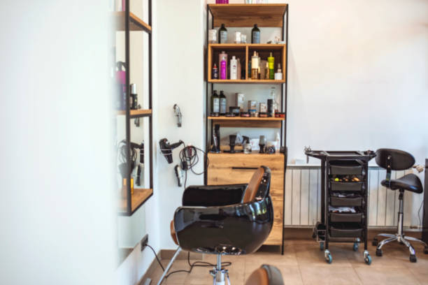 istock Empty black chairs and mirrors in barber shop. 1264049473