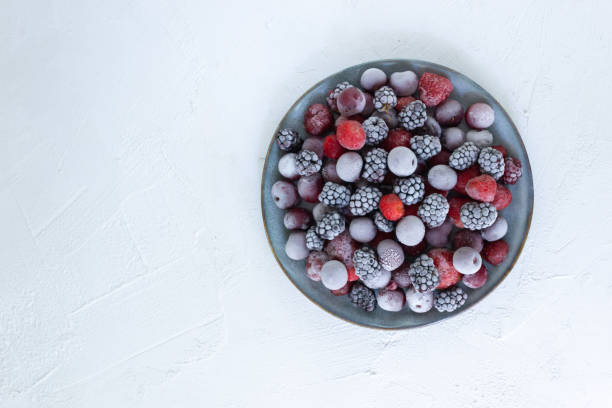 istock Frozen berries in a gray plate on a white background. 1264054925