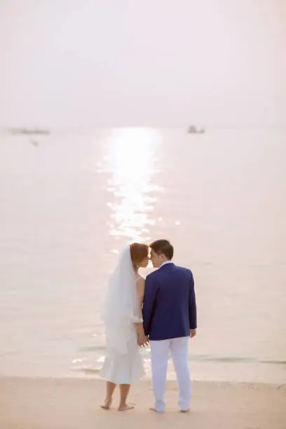 Young asian groom and bride posing and smiling for pre-wedding shot