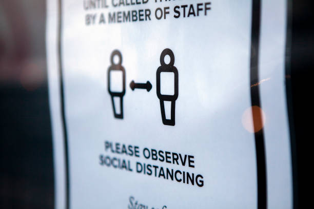 istock Social distancing notice on shop door 1264056509