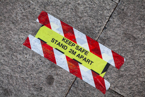 istock Tape markers on sidewalk for customer social distancing 1264056557