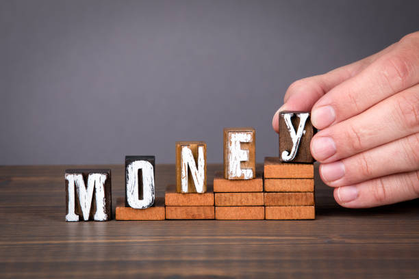 istock MONEY. Economic growth, development and profits concept. Wooden alphabet letters on steps 1264057608