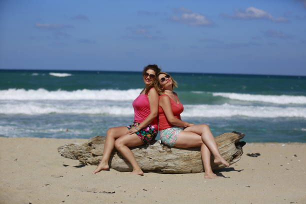 istock young women having a good time on the beach with waves 1264058223