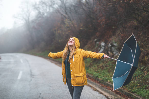 istock Joyful woman walking in rainy weather 1264060470
