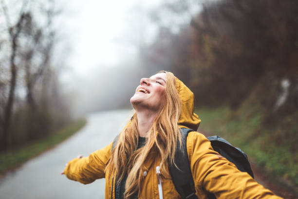 istock Joyful woman walking in rainy weather 1264060695