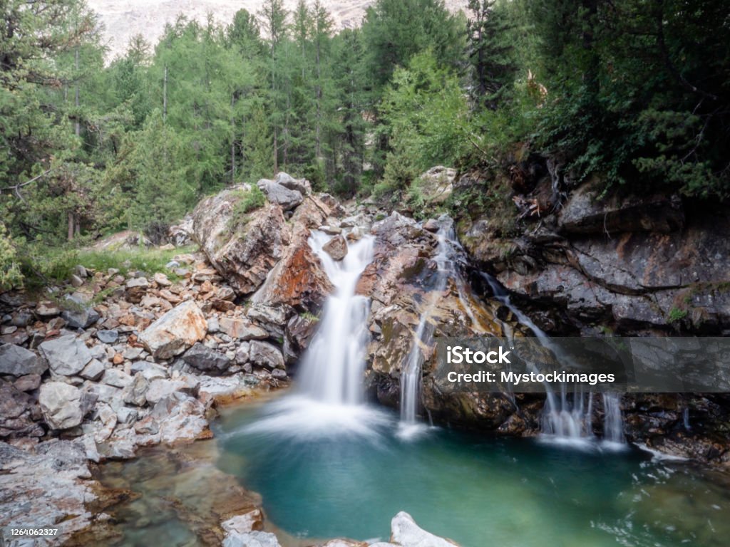 Pretty waterfall in the Swiss Alps, Graubunden canton Beautiful alpine waterfall in Graubunden Canton, Switzerland, Summer season Switzerland Stock Photo