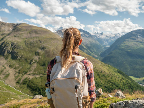 istock Young woman on mountain trail contemplating the view 1264062524