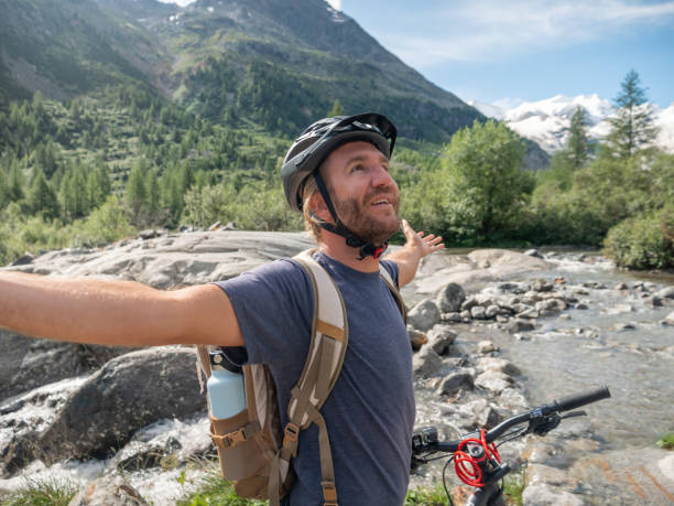 istock Mountain biker  arms outstretched enjoying nature 1264062773