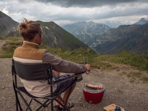istock Man making ribs on barbecue on top of mountain pass 1264063397
