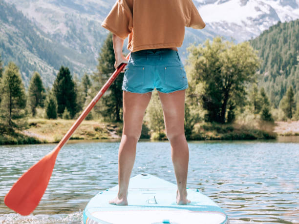istock Stand up paddle with a view, woman on SUP in the mountains looking at glacier 1264064108
