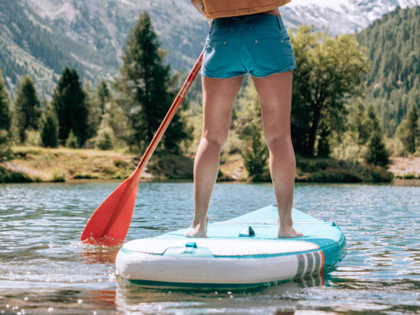 istock Stand up paddle with a view, woman on SUP in the mountains looking at glacier 1264065904