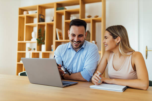 istock Couple of cheerful friendly colleagues at work. 1264067893