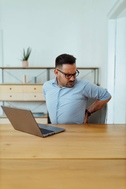 istock Businessman has a pain at work with a laptop. 1264067914