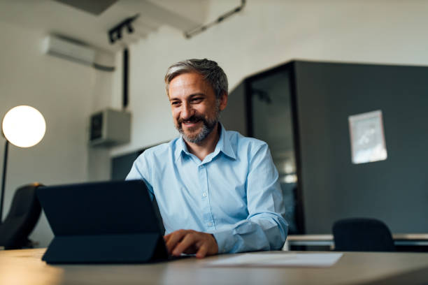 istock Portrait of a smiling businessman using digital tablet. 1264067926