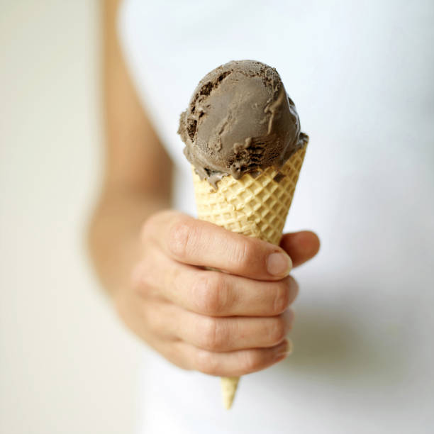 istock Close up of the hand holding ice cream 1264070268