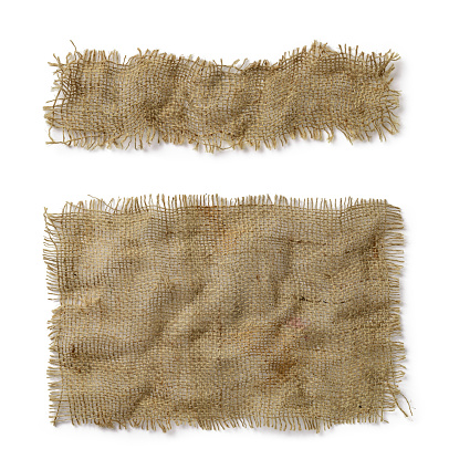 Crumpled burlap rectangular and oblong pieces isolated on white background. Natural color sackcloth patch with torn edges. Rough fabric woven of flax, jute or hemp. Design element. Top view.