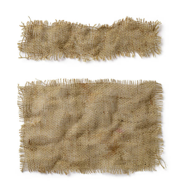 Crumpled burlap rectangular and oblong pieces isolated on white background. Natural color sackcloth patch with torn edges. Rough fabric woven of flax, jute or hemp. Design element. Crumpled burlap rectangular and oblong pieces isolated on white background. Natural color sackcloth patch with torn edges. Rough fabric woven of flax, jute or hemp. Design element. Top view. torn fabric stock pictures, royalty-free photos & images