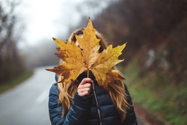 Young woman holding leaf