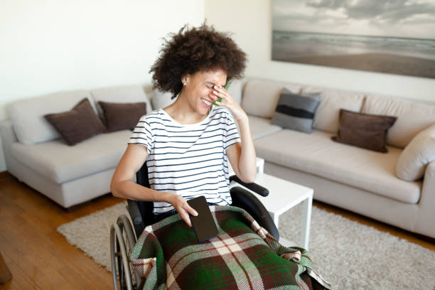 istock Young disabled and smiling African American woman using a smart phone 1264071992