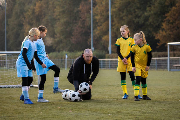 istock Soccer father coaching football daughter's team during a training session 1264072284