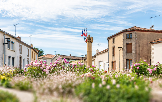 Monument with French flags in town square Les Epesses, France