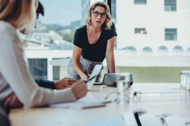 istock Woman explaining new strategies to her team 1264073858