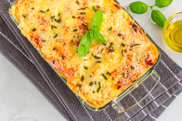 Traditional Italian Baked Pasta with Chicken Garnished with Basil Leaves Directly from Above Horizontal Photo Baked Pasta Directly Above Close-Up Photo chicken rigatoni stock pictures, royalty-free photos & images