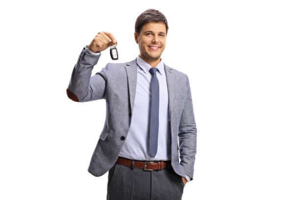 istock Guy in formal clothing holding a car key 1264073864