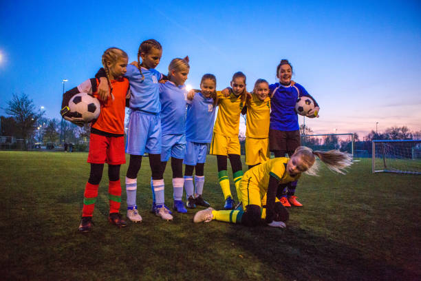istock Female Girl Soccer Team celebrating as a group 1264074228