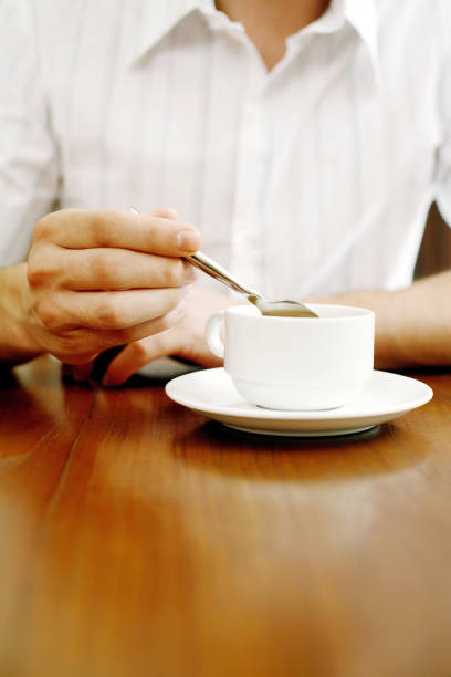 istock Man stirring a cup of coffee 1264076828