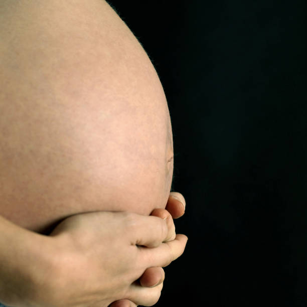 istock Pregnant woman touching her stomach 1264078495