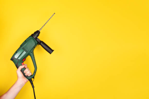 istock Green Puncher in the hands of a builder. 1264081718
