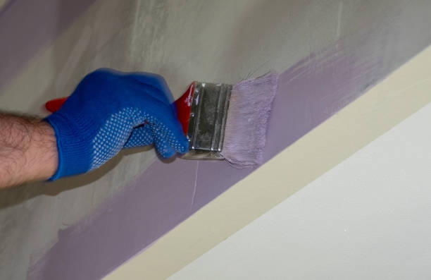 istock Man plastering a white wall preparing it for painting or wallpapering in a DIY and home decoration or renovation concept. 1264084672